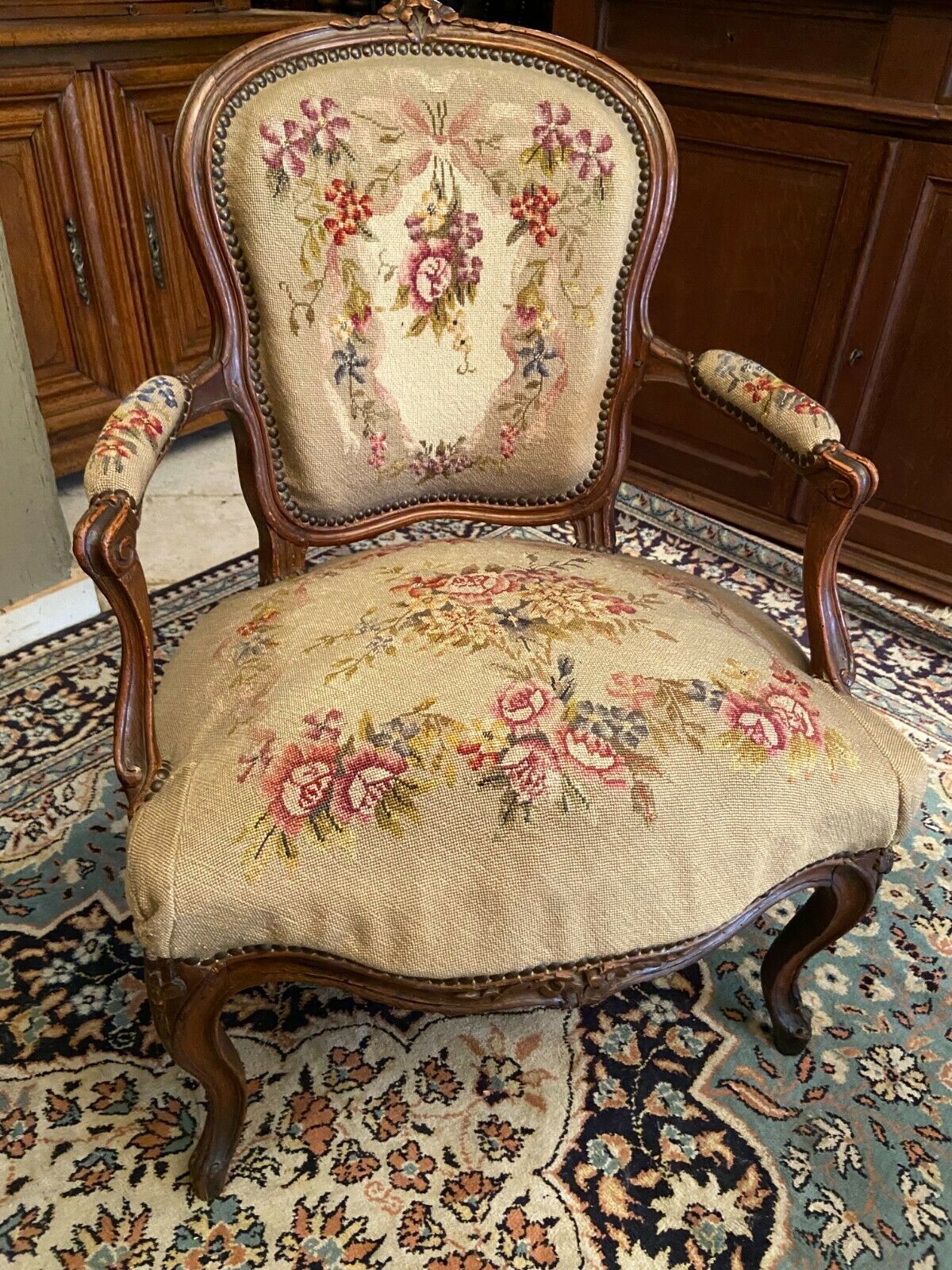 Armchair cabriolet eighteenth period Louis XV tapestry to the point floral decoration