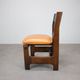 Vintage German sculptural chair from the 1970s in wood with orange faux leather.