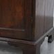 Charming and timeless antique English oak cabinet/commode from the early 19th century with two doors and a working lock