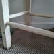 Vintage wooden stool with white peeling paint