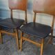 Set of 2 vintage Scandinavian chairs in teak and black faux leather by Kofod-Larsen, Denmark, 1960s.