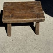 Small stool, rectangular solid teak side table with curved legs.