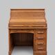 Oak desk with sliding door and leather wood chair.