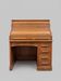 Oak desk with sliding door and leather wood chair.