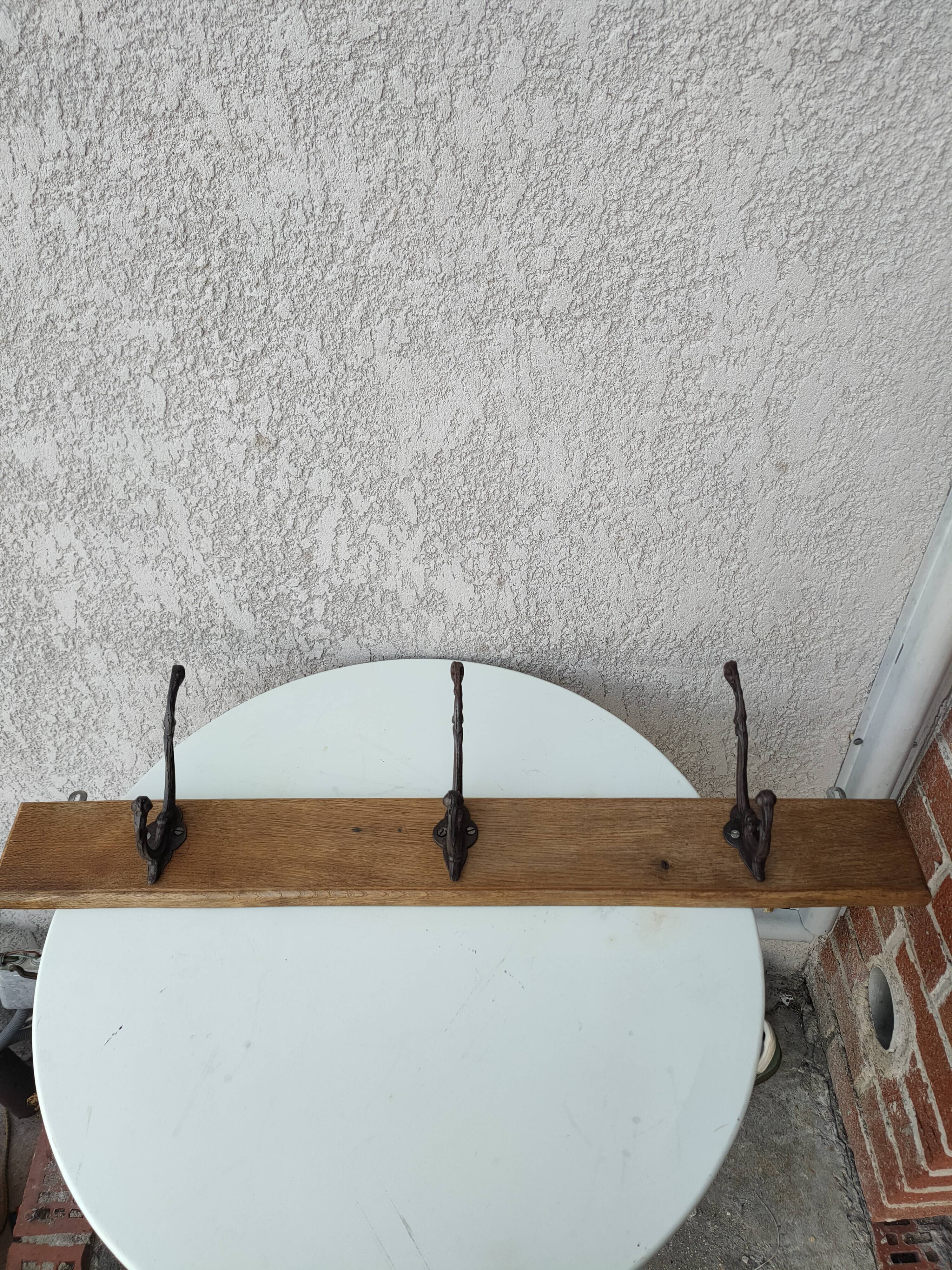 antique coat rack with 3 cast iron hooks