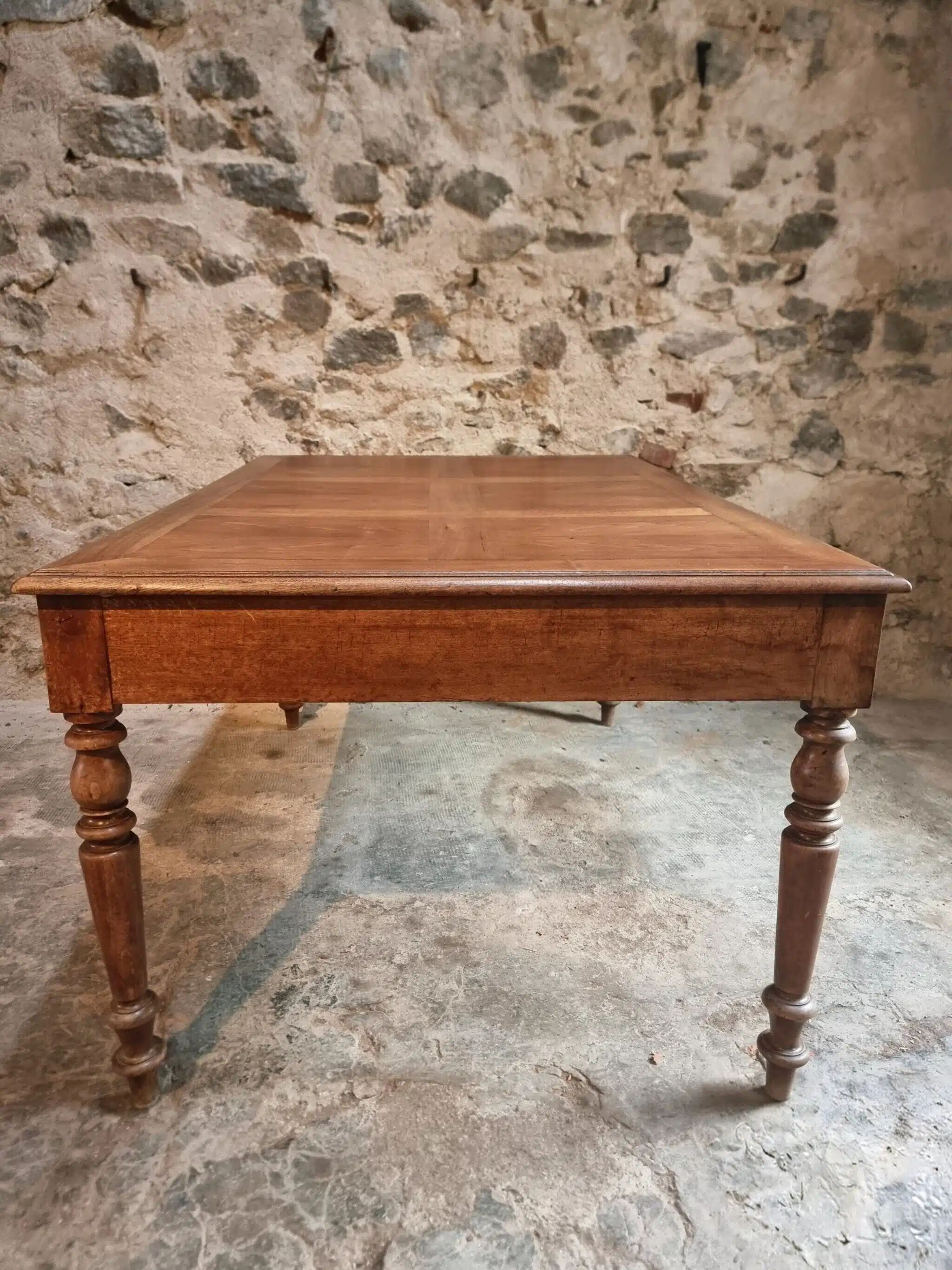 Antique French walnut table with six drawers, parquet top, early 20th century.