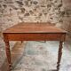 Antique French walnut table with six drawers, parquet top, early 20th century.