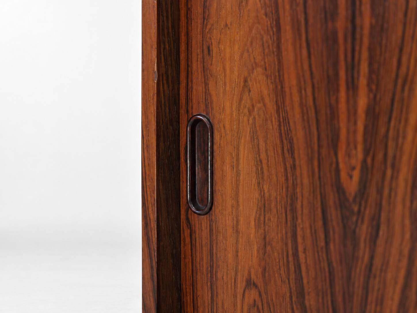 Low sideboard in rosewood with sliding doors. Denmark, 1960s