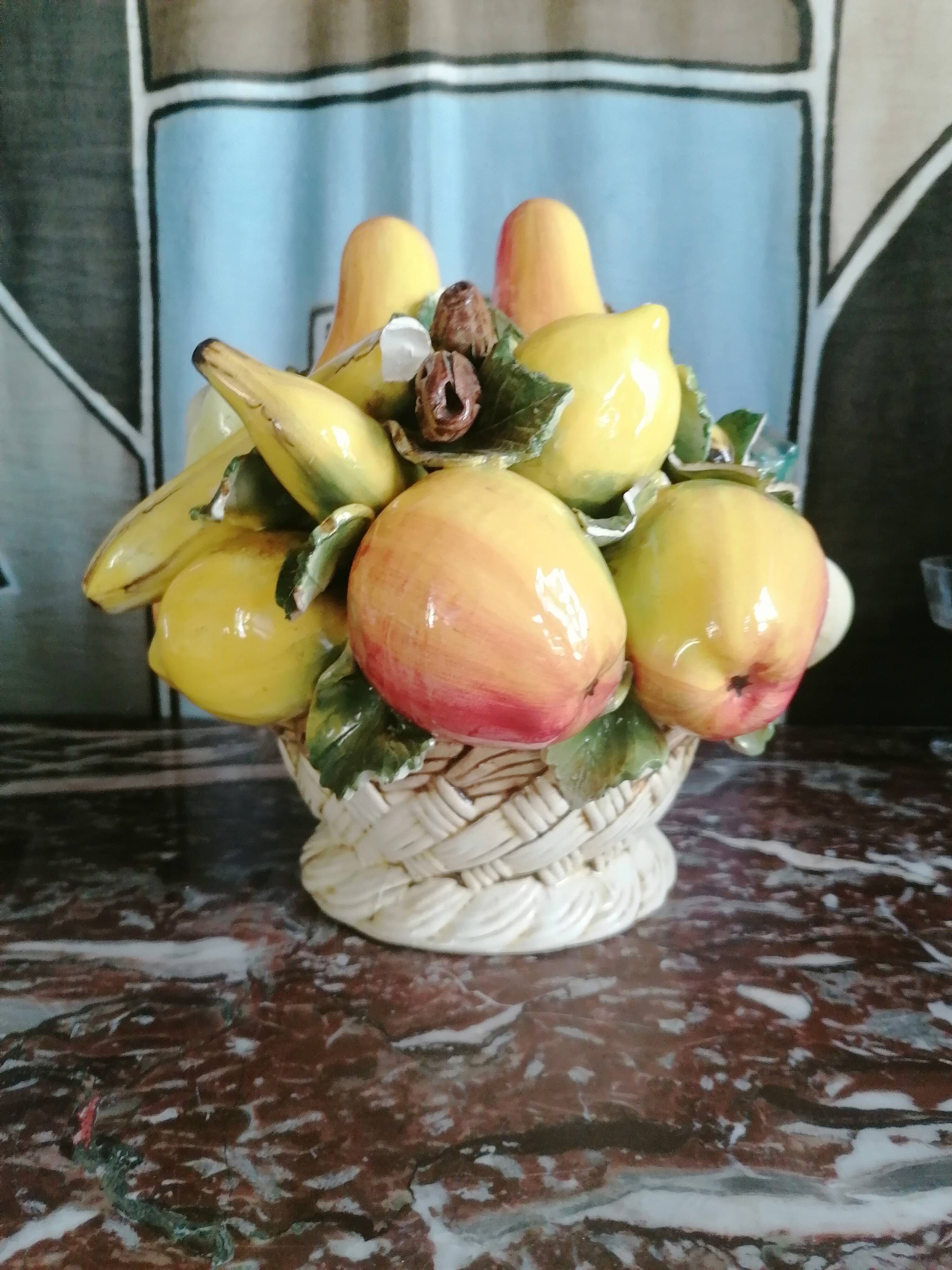 Basket with ceramic fruit decoration