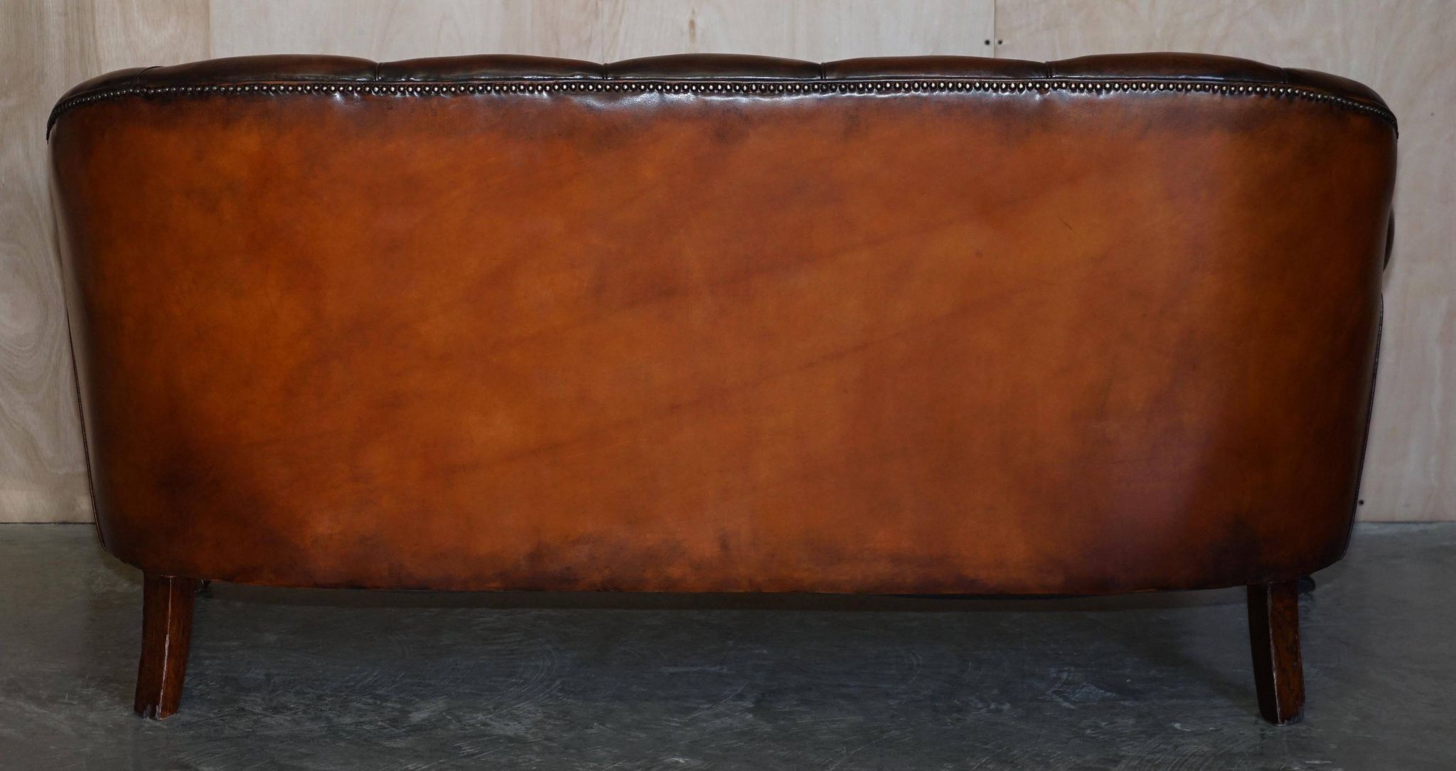 Victorian Chesterfield leather canapé with oak lion claw feet.