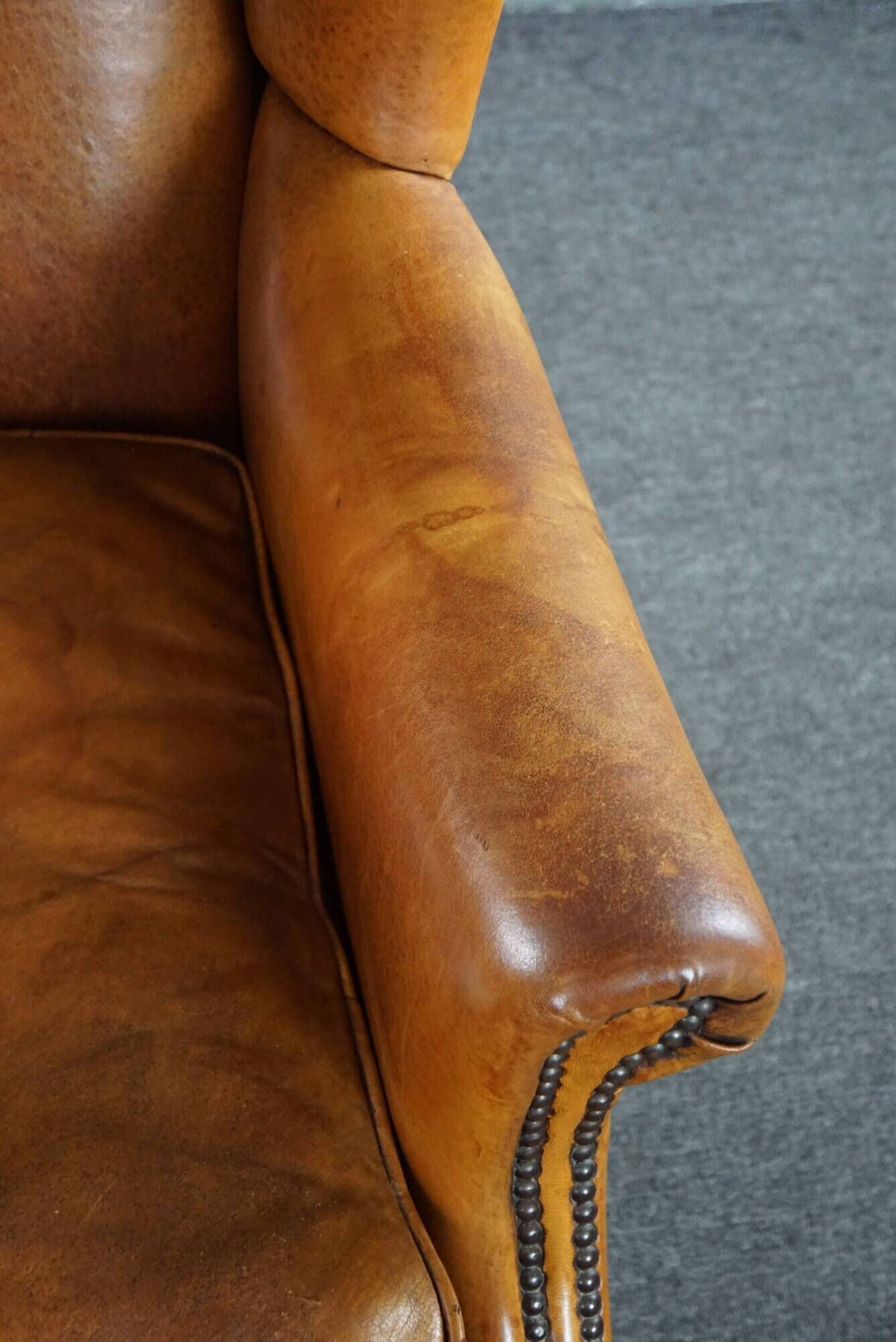 Wingback chair made of sheepskin leather in a light honey color
