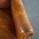 Wingback chair made of sheepskin leather in a light honey color