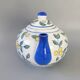 Blue teapot and yellow fruits