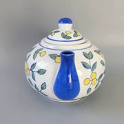 Blue teapot and yellow fruits