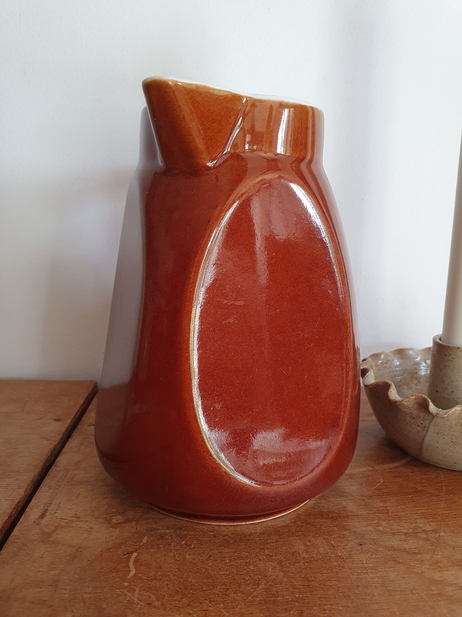Pitcher in brown sandstone