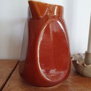 Pitcher in brown sandstone