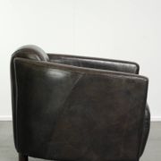 Cow leather Aviator design armchair in a dark colour scheme