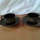 Black cups and saucers with relief decoration