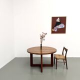 Modernist round table in solid elm, crossed legs.