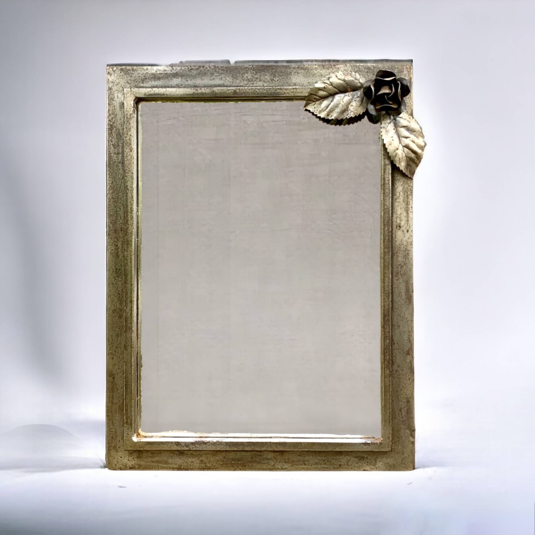 Vintage wall mirror in varnished steel decorated with a rose in relief