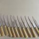 Set of 12 antique knives in green case