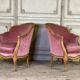 Pair of Louis XV style bergère armchairs in carved wood, pink velvet, circa 1900