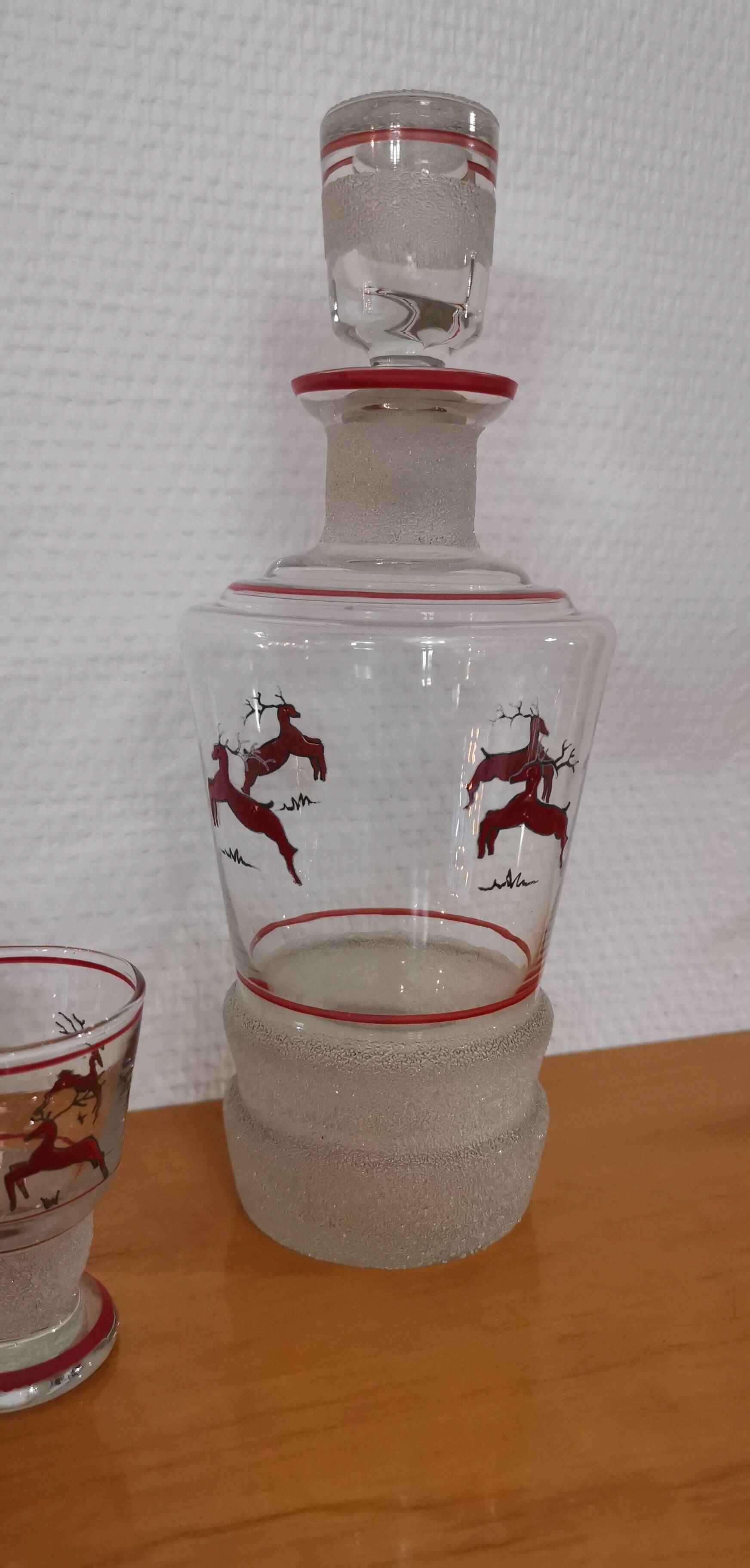 Glasses and carafe decorated with red Christmas reindeer and white granita 60's
