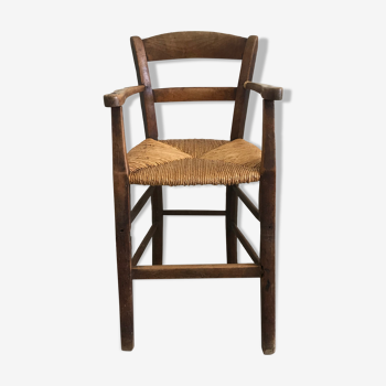 Old wooden child high chair with mulched seat
