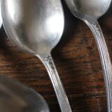 A set of 6 silver-plated metal soup spoons with foliage design.