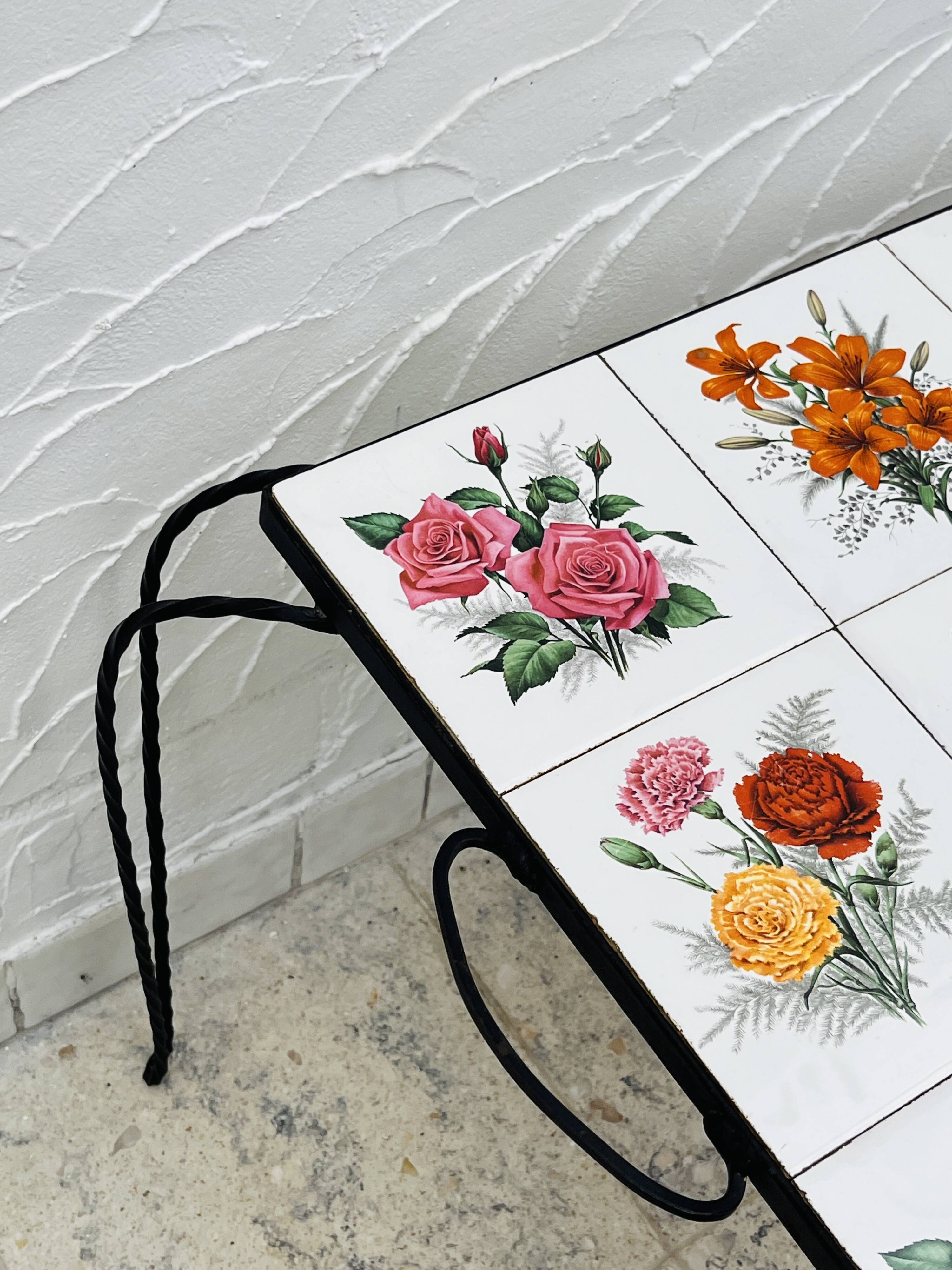 Vintage coffee table in wrought iron with floral tiles.