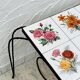 Vintage coffee table in wrought iron with floral tiles.