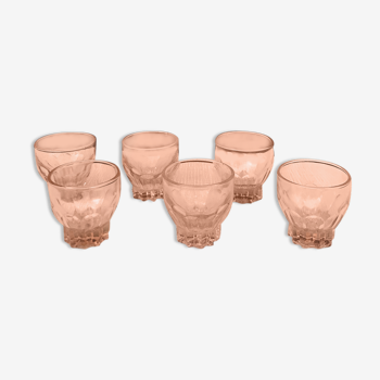 Six small pink glasses