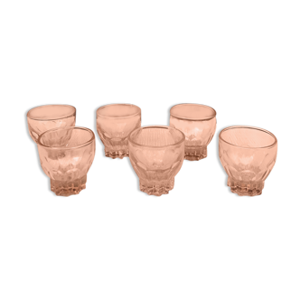 Six small pink glasses