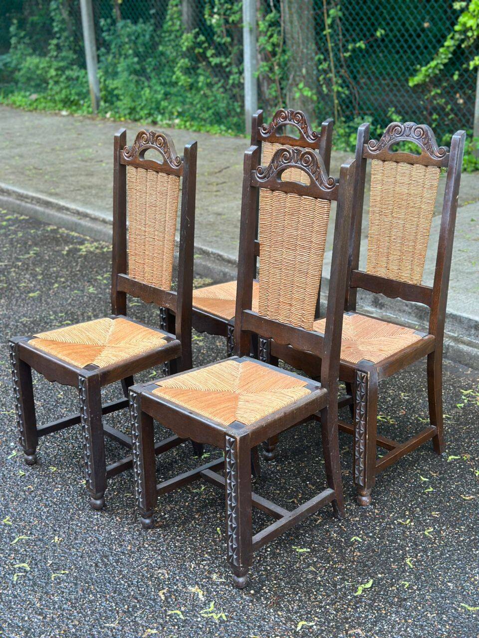4 Basque solid wood dining chairs with carved straw seats.