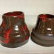 Pair of red vases in the shape of an elephant's foot
