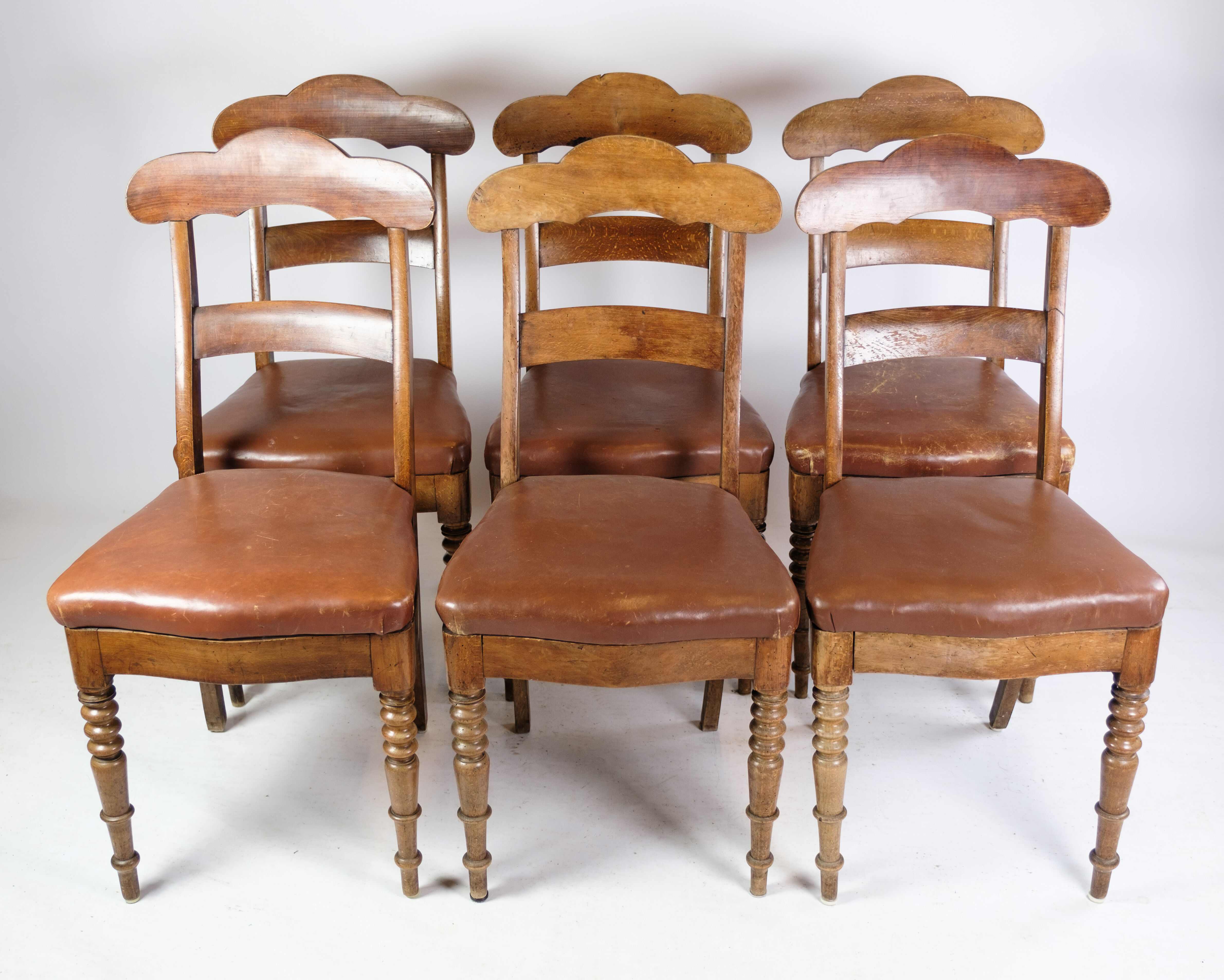 Set of eight late empire chairs in high quality brown leather in mahogany