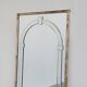 Large Art Deco style beveled wall mirror with architectural arch design