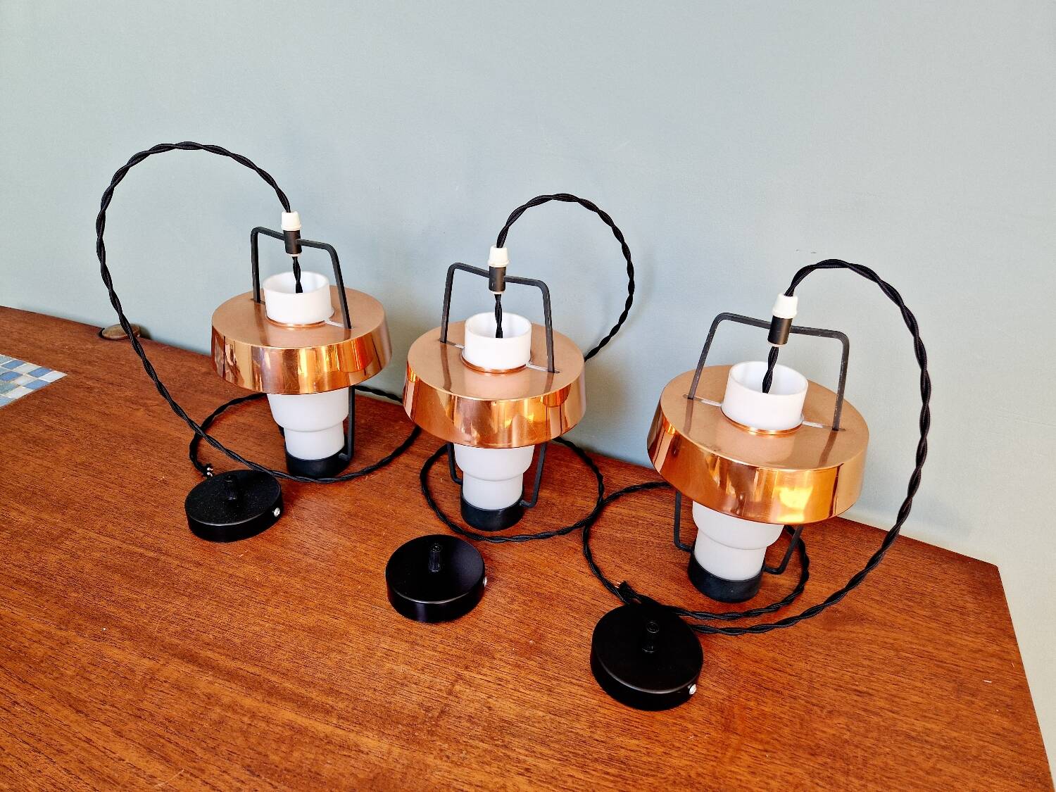Trio of Scandinavian pendant lights in opaline and copper metal, 1960s