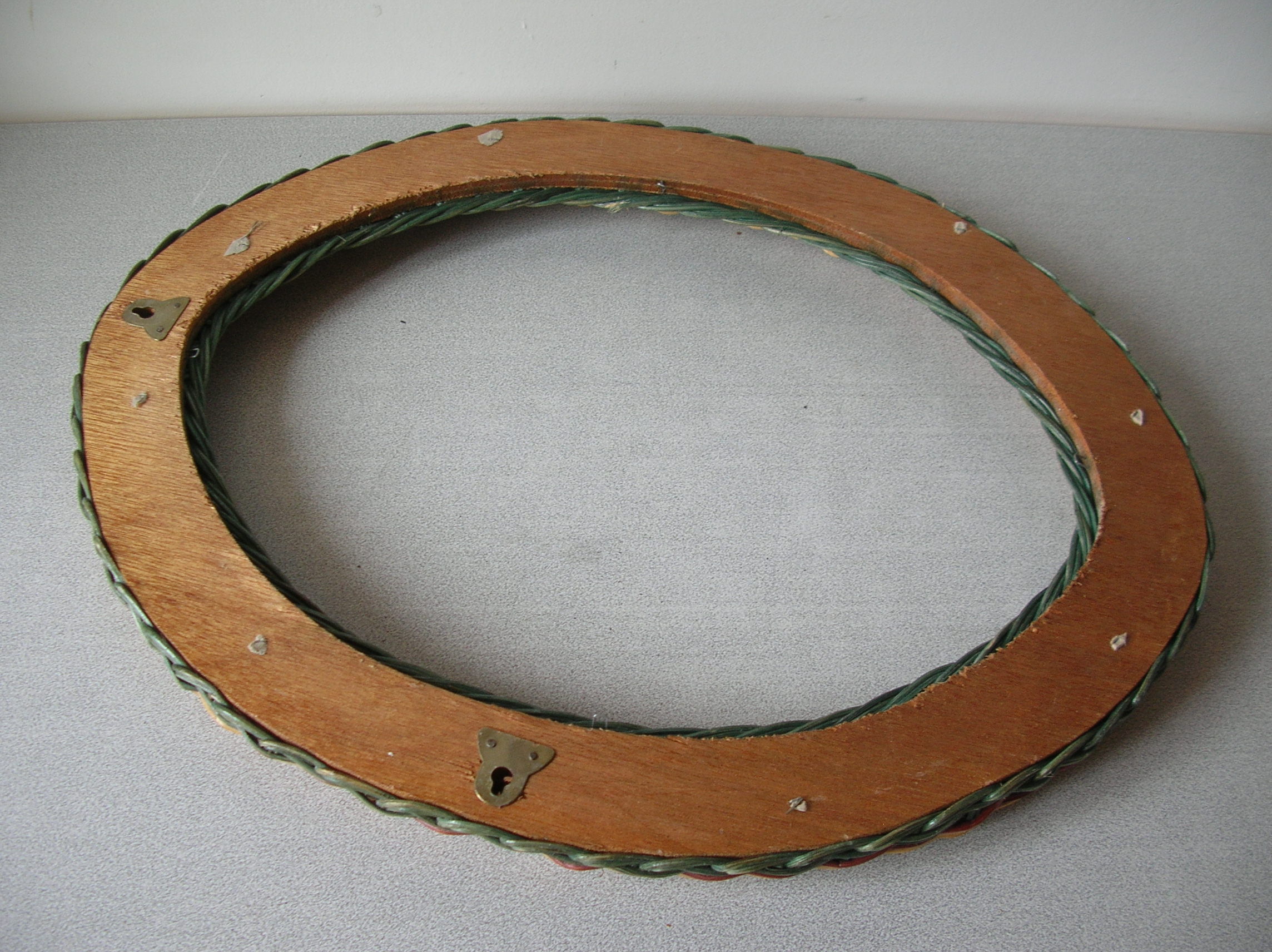 Old oval frame in rattan and wood photo door mirror frame