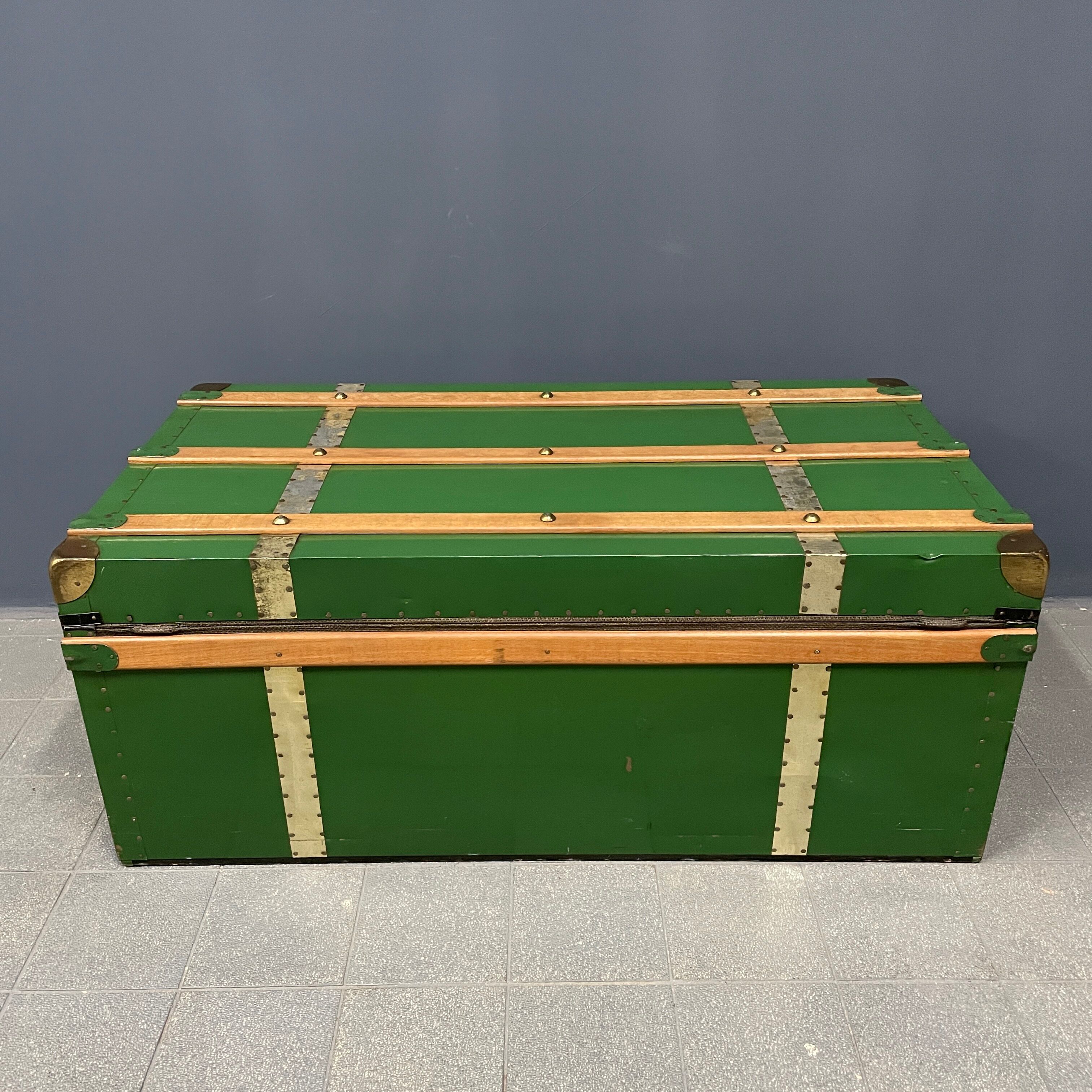 Green metal trunk with wooden sleds