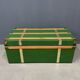 Green metal trunk with wooden sleds