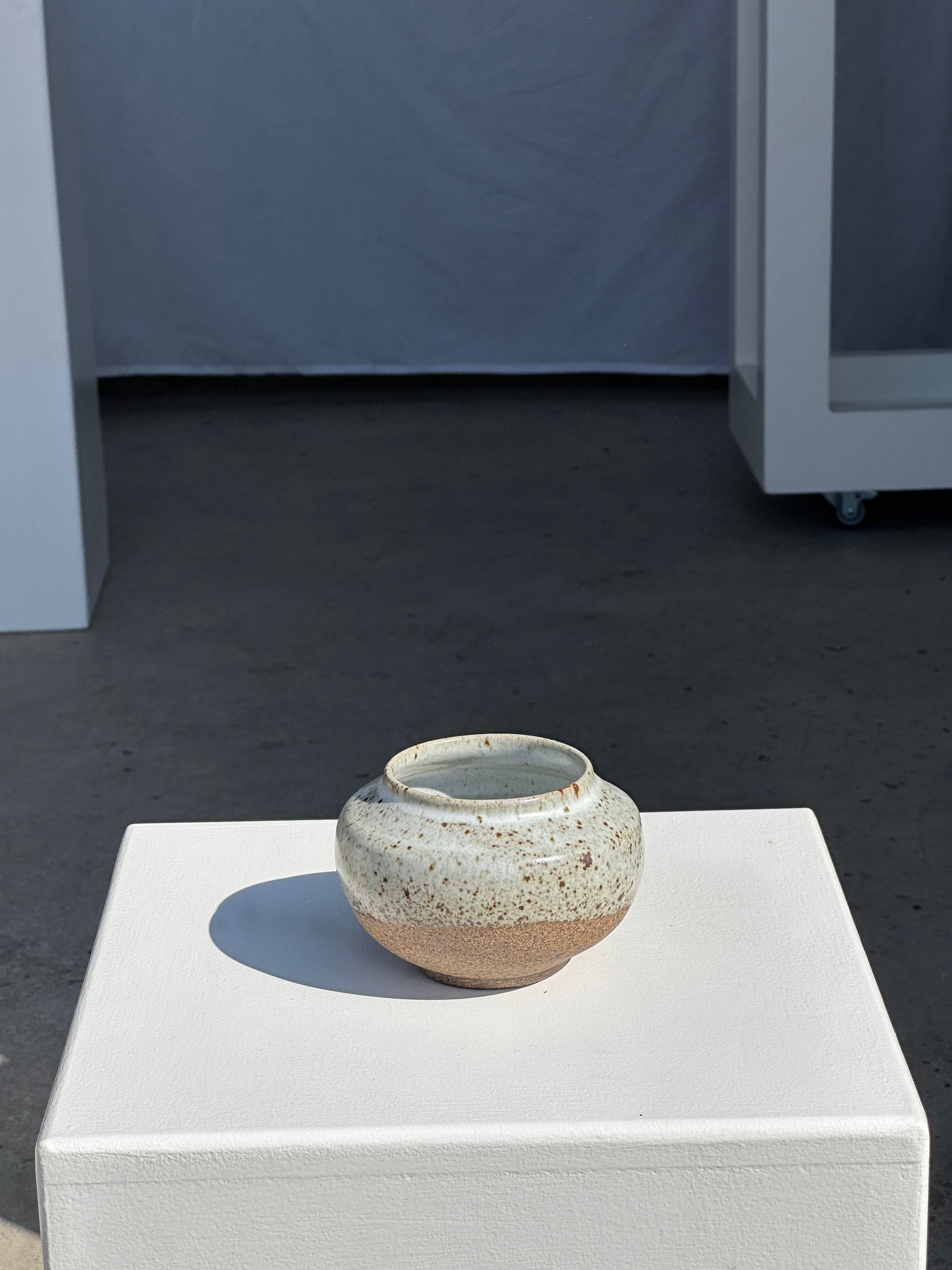 Small white ball vase tight neck in glazed speckled ceramic
