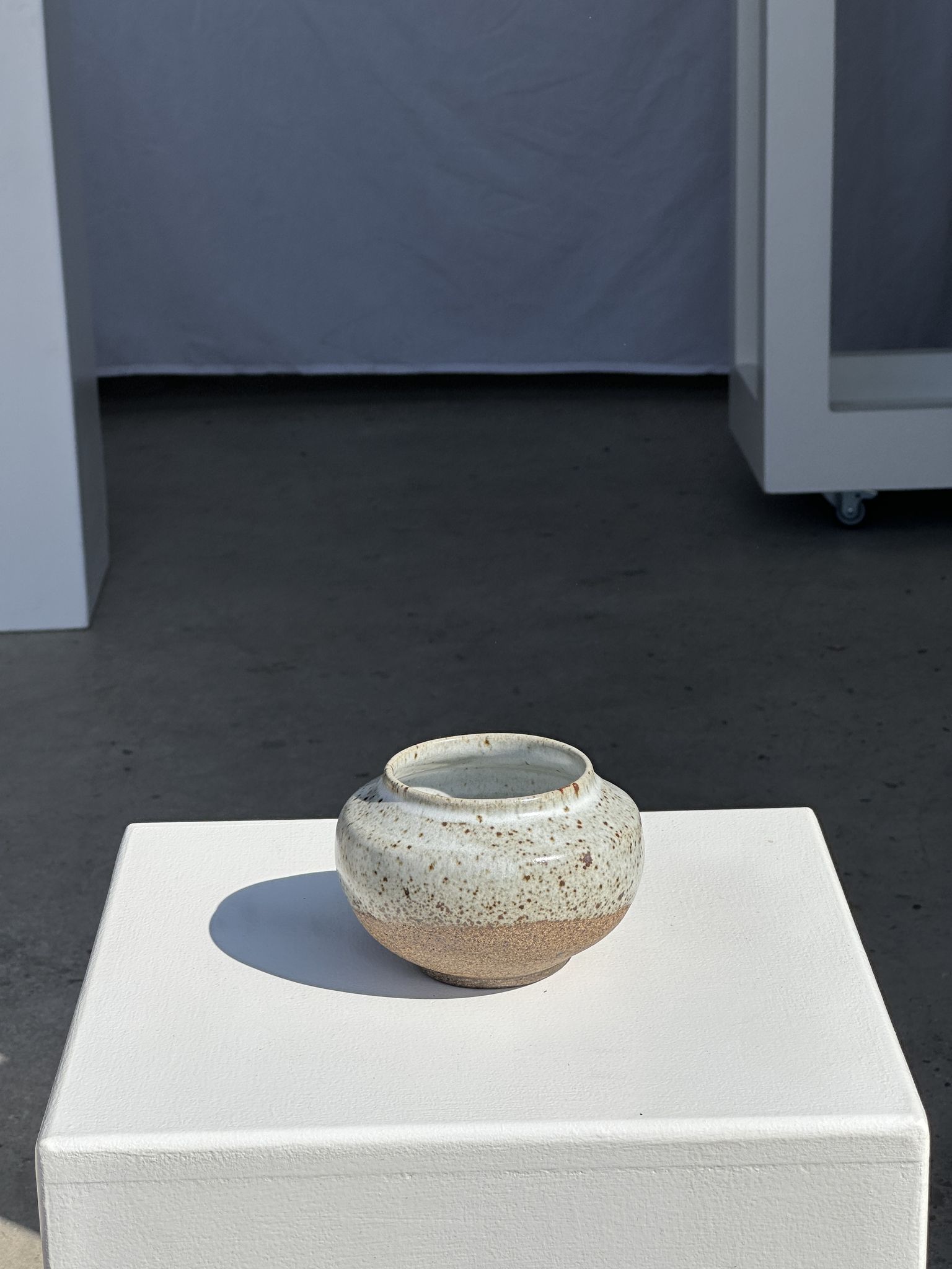 Small white ball vase tight neck in glazed speckled ceramic
