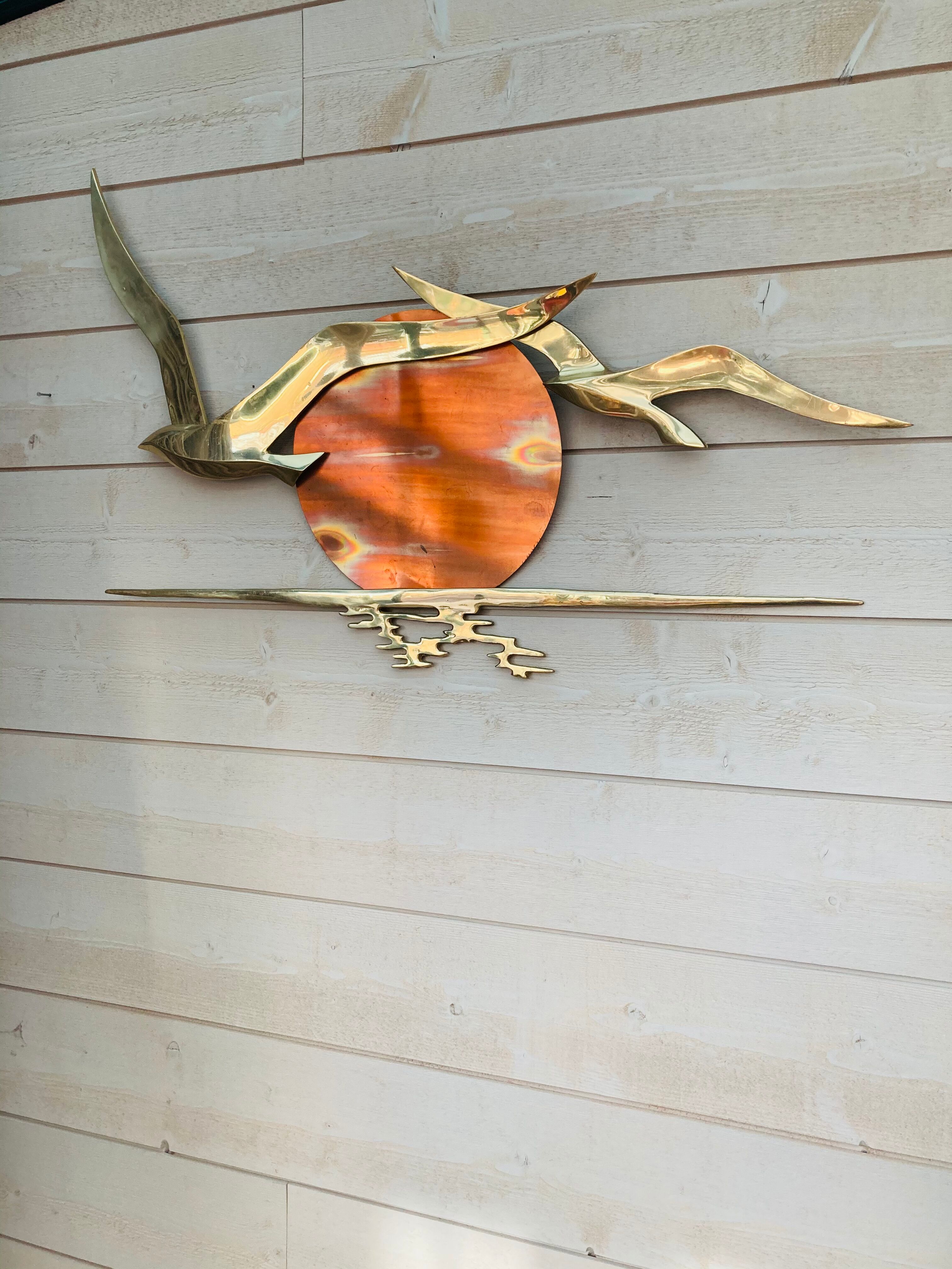 Bird brass and sun bronze wall decoration