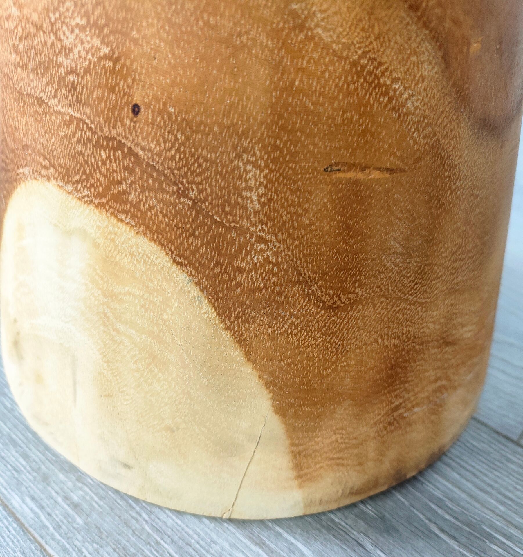 Minimalist side table in solid suar wood with conical legs.