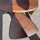 Nested tripod tables made of solid wood, in a modernist brutalist style.