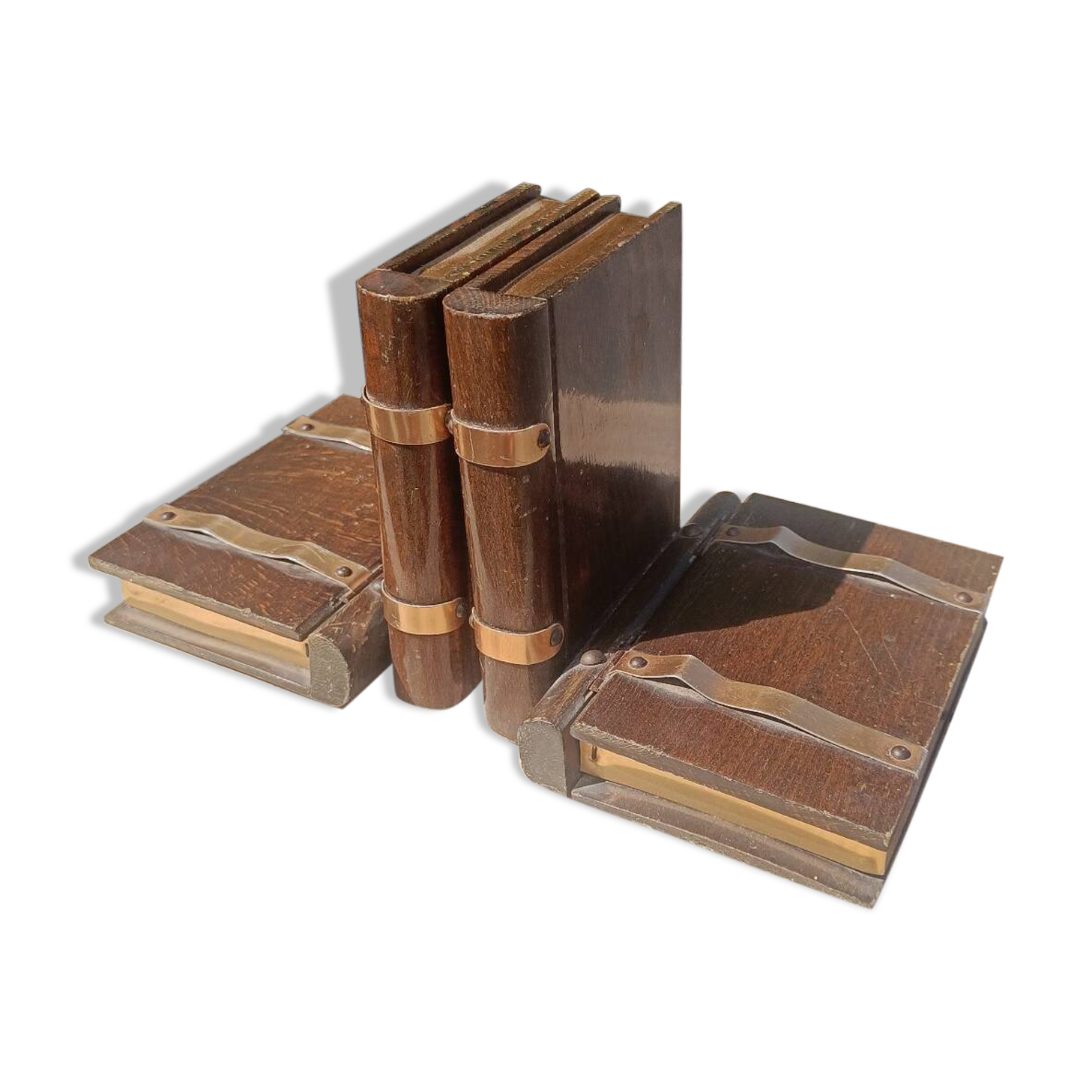 Wooden trompe-l'œil bookends with a book and box.