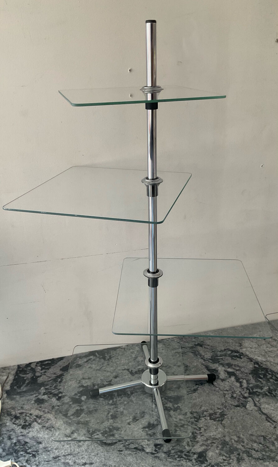 A pair of vintage side tables in glass and chrome metal.