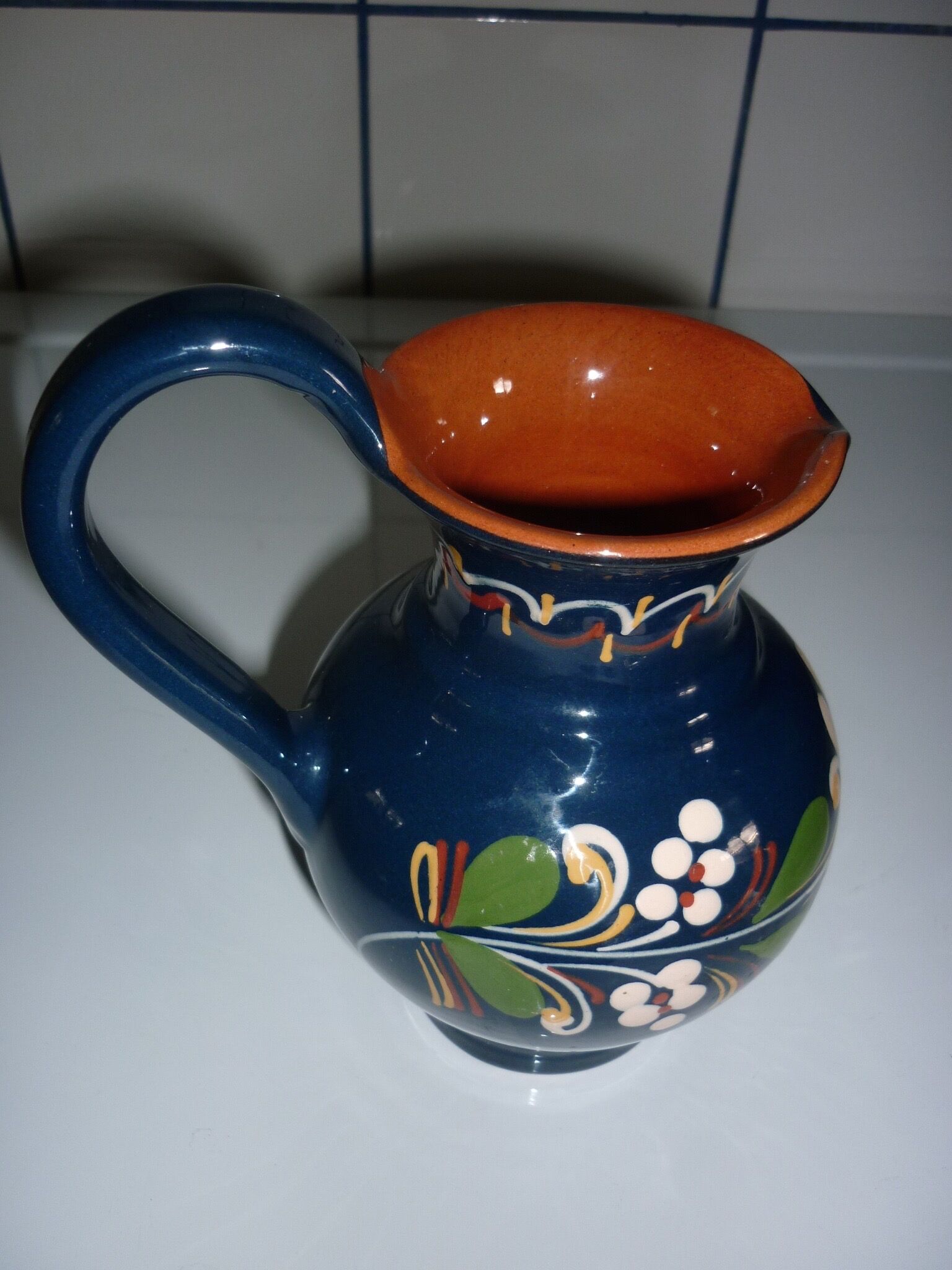 Blue glazed earth pitcher and flowers