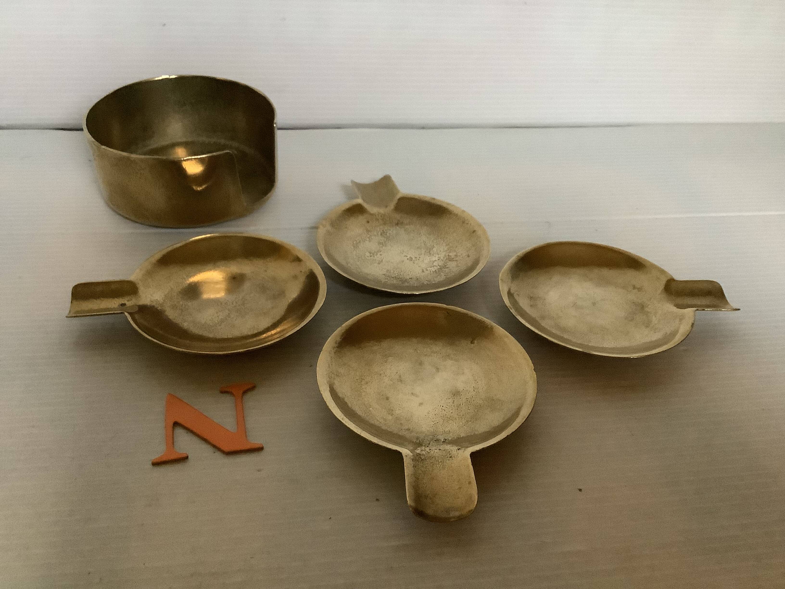 Four individual brass ashtrays